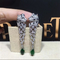 C Cheetah Earrings - showing the charm of courage, naughty or docile .310 round bright cut diamonds, emerald and onyx. supplier